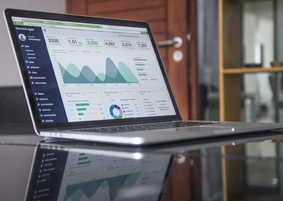 Analytics charts on a laptop screen.